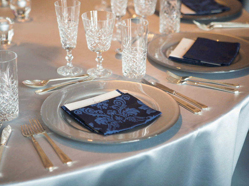 Silver Milano table linen, Silver charger plate paired with French Navy Vintage Damask napkin and Cut Crystal glassware