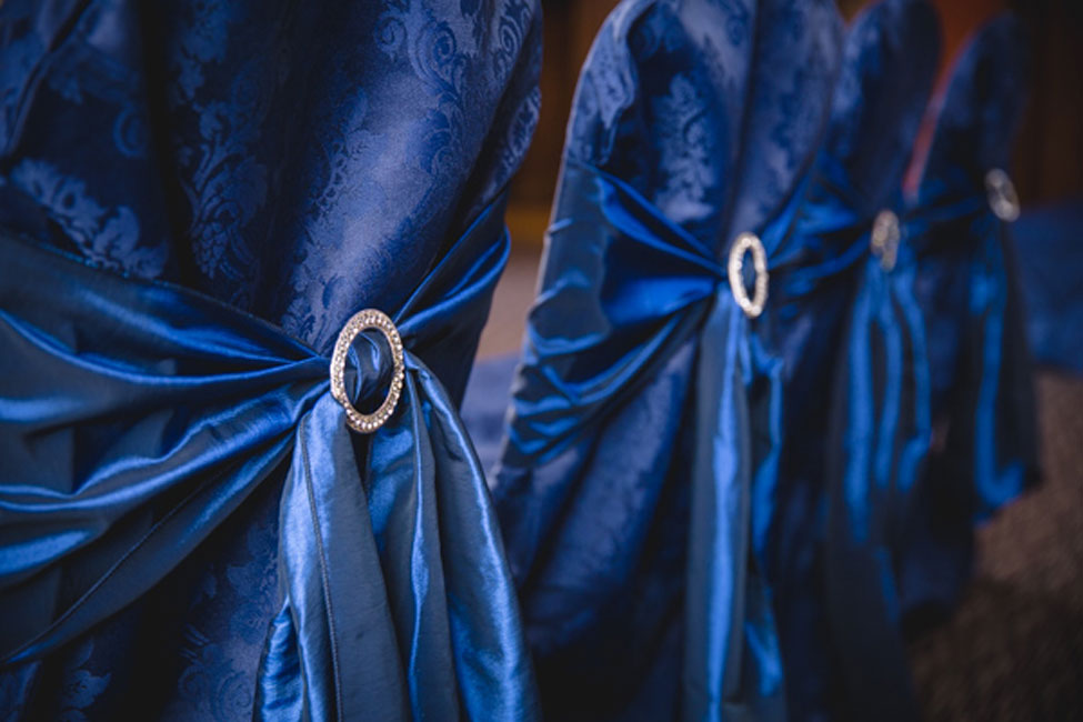 French Navy Vintage Damask chair covers paired with Midnight Taffeta seat ties and diamante buckles