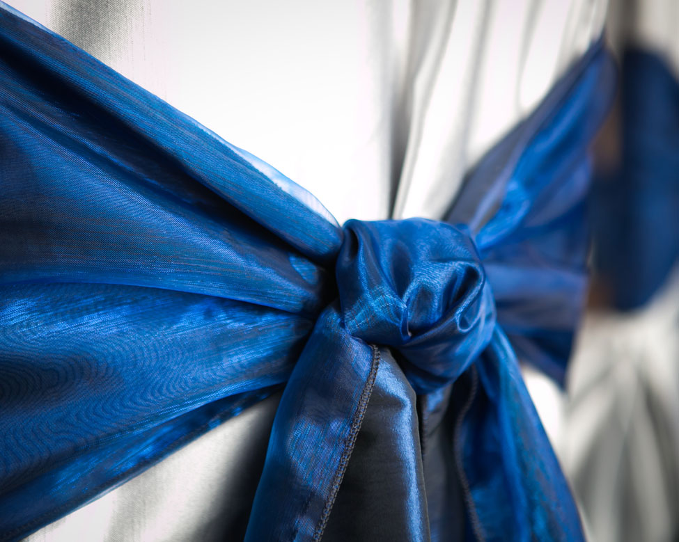 Midnight Blue Taffeta and Organza seat ties paired with Silver Milano chair covers at Trump Turnberry Resort