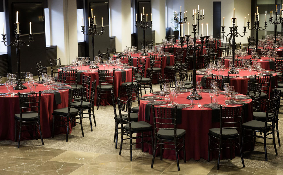 Wine Essential table linen, Black Chiavari Chiars with Black Essential seat pads, Black Essential napkins paired with Smoke Grey charger plates, Smoke Grey glasses and Black Gloss Candelabras