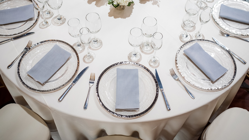 Cream Essential tablecloth and Grigio Gelato napkins with Silver Trim chargers