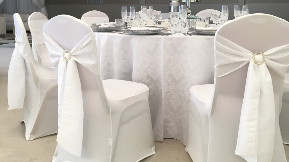 White Damask tablecloth with White Italian Stretch chair covers