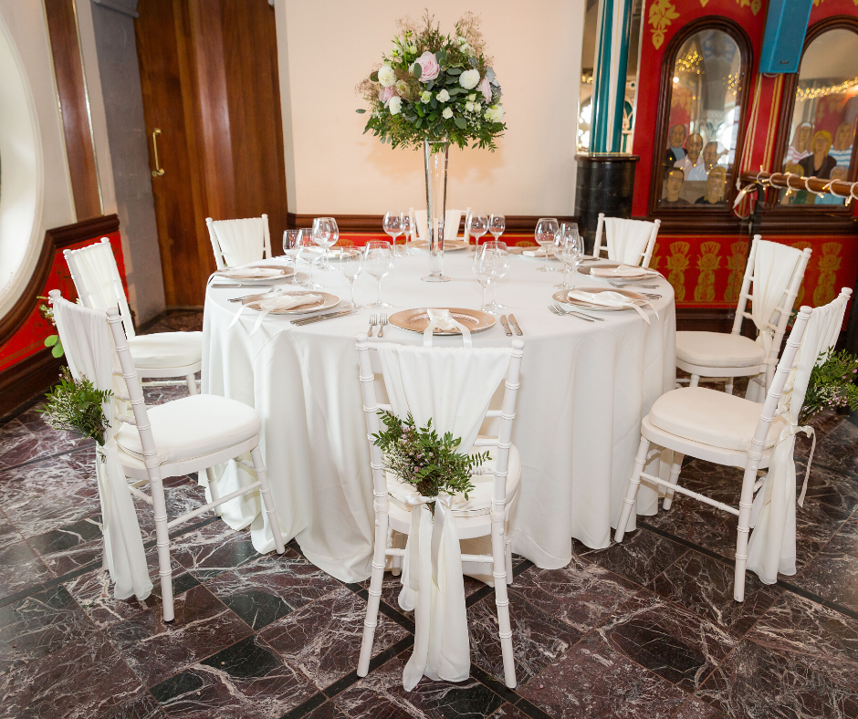 Cream Essential tablecloth with Rose Gold Starburst chargers and Ivory Chiavari chairs