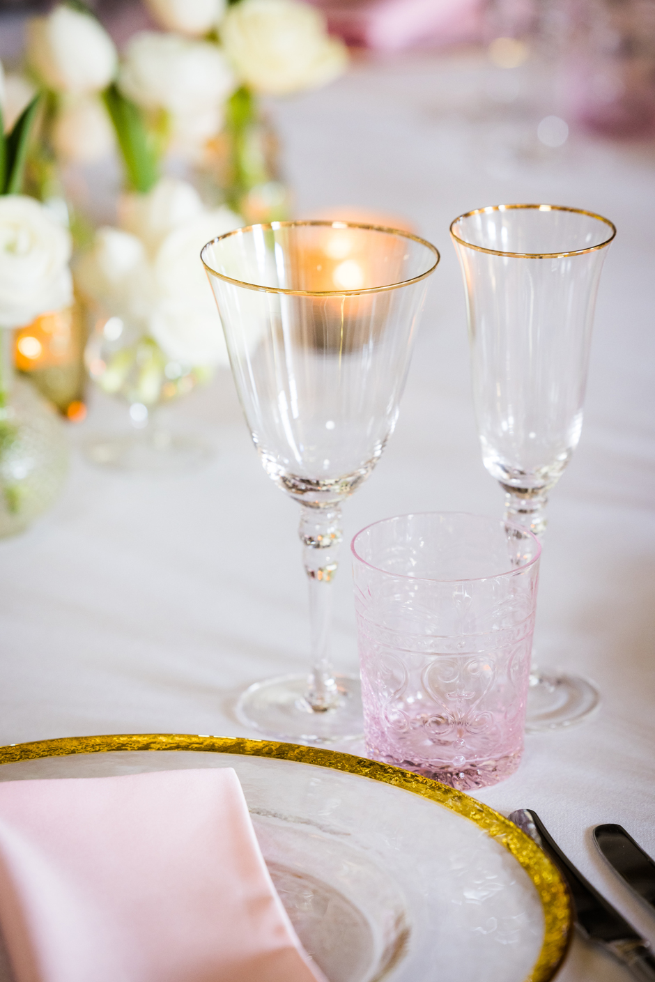 Pink water glass with white Essential linen, blush Verona napkin, gold trim charger plate & gold trim glasses